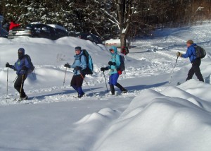 Mission Accomplished! This snowshoe group had just found their way back to the Cardigan Lodge by bushwhacking off the trails, through untracked woods, guided only by map and compass.